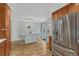 Well-lit kitchen featuring stainless steel appliances, a center island with bar stools, and hardwood floors at 7444 S Milwaukee Ct, Centennial, CO 80122