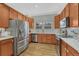 Well-appointed kitchen featuring stainless steel appliances, light countertops, and ample cabinet space for storage at 7444 S Milwaukee Ct, Centennial, CO 80122
