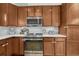 Charming kitchen featuring stainless steel appliances, light countertops, and abundant wood cabinetry at 7444 S Milwaukee Ct, Centennial, CO 80122