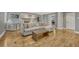 Open-concept living room with hardwood floors, a fireplace, a comfortable couch, and access to other rooms at 7444 S Milwaukee Ct, Centennial, CO 80122