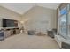 Bright living room with a high ceiling, modern entertainment center and a decorative wall sketch feature at 7444 S Milwaukee Ct, Centennial, CO 80122