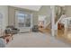 Open living room featuring a large window, neutral color palette, hardwood entry and staircase at 7444 S Milwaukee Ct, Centennial, CO 80122