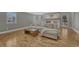 Bright living room with a gray couch, wood floors, a brick fireplace, and backyard access at 7444 S Milwaukee Ct, Centennial, CO 80122