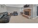 Relaxing living room with a comfortable leather sofa, brick fireplace, and a wall-mounted television at 7444 S Milwaukee Ct, Centennial, CO 80122