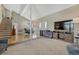 Spacious living room with open floor plan, hard wood entry, entertainment center, and staircase at 7444 S Milwaukee Ct, Centennial, CO 80122
