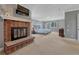 Large main bedroom with a brick fireplace, neutral tones, and carpet flooring at 7444 S Milwaukee Ct, Centennial, CO 80122