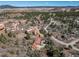 Aerial view of a home nestled amidst a landscape of trees and rock formations at 6601 Pike Cir, Larkspur, CO 80118