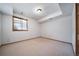 Bright, carpeted basement area with a window and plenty of natural light at 6601 Pike Cir, Larkspur, CO 80118