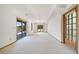 Spacious, naturally-lit basement area with large windows and doors offering scenic outdoor views at 6601 Pike Cir, Larkspur, CO 80118