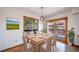 A sunny dining room has a view and a wooden table with seating for six at 6601 Pike Cir, Larkspur, CO 80118