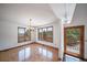 Dining room featuring parquet floors, natural light from large windows, and deck access with great views at 6601 Pike Cir, Larkspur, CO 80118