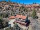 Two-story home with a red tiled roof, two wooden decks, siding and an attached three car garage at 6601 Pike Cir, Larkspur, CO 80118