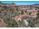 Two-story home with an attached three car garage, a red tiled roof and siding surrounded by trees at 6601 Pike Cir, Larkspur, CO 80118