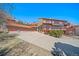 A beautiful home boasts a long driveway and three car garage, with a large deck and mountain views at 6601 Pike Cir, Larkspur, CO 80118