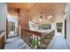 An open foyer features skylights and a brick fireplace, offering a view down to the main floor at 6601 Pike Cir, Larkspur, CO 80118