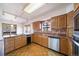 Kitchen features wood cabinets, stone countertops, and stainless steel appliances at 6601 Pike Cir, Larkspur, CO 80118