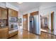 The kitchen boasts stainless steel appliances, wood cabinets, and an adjoining room at 6601 Pike Cir, Larkspur, CO 80118