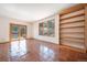 Bright living room boasts terra cotta tile flooring, built-in shelving, balcony access, and natural light through large windows at 6601 Pike Cir, Larkspur, CO 80118