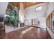 Bright living room with soaring ceilings, a large brick fireplace, and terra cotta tile flooring at 6601 Pike Cir, Larkspur, CO 80118