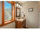 Bathroom with wood accents, granite countertop and lovely backyard view at 804 Clear Creek Rd, Evergreen, CO 80439