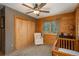 Comfortable room with wood paneled walls and large windows with mountain views, featuring a wooden closet and crib at 804 Clear Creek Rd, Evergreen, CO 80439