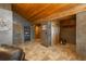 Hallway with unique doors, wood beams, and accent wall at 804 Clear Creek Rd, Evergreen, CO 80439