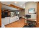 Open-concept living room with wood floors, beamed ceiling, and large windows providing ample natural light at 804 Clear Creek Rd, Evergreen, CO 80439