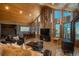 Living room with wood walls, wood ceilings, and mountain views at 804 Clear Creek Rd, Evergreen, CO 80439