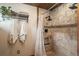 Shower with tile surround, multiple shower heads, and a built-in niche for storage at 804 Clear Creek Rd, Evergreen, CO 80439