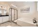 Spa-like bathroom featuring a walk-in shower and a soaking tub at 6506 Barnstead Dr, Castle Pines, CO 80108