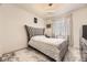 Guest bedroom with plush bed and modern gray accents at 6506 Barnstead Dr, Castle Pines, CO 80108