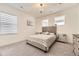 Bright bedroom with a comfortable bed and ample natural light at 6506 Barnstead Dr, Castle Pines, CO 80108