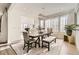 Bright dining room with a large table and bench seating for six at 6506 Barnstead Dr, Castle Pines, CO 80108