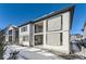 Modern two-story home with covered patio and snowy yard at 6506 Barnstead Dr, Castle Pines, CO 80108
