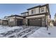 Two-story home with attached two-car garage and snow-covered driveway at 6506 Barnstead Dr, Castle Pines, CO 80108