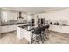Modern kitchen with white cabinets, large island, and stainless steel appliances at 6506 Barnstead Dr, Castle Pines, CO 80108