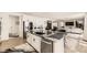Open concept kitchen with large island and stainless steel appliances at 6506 Barnstead Dr, Castle Pines, CO 80108