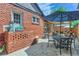 Backyard patio with brick elements, a dining table, chairs and a shade pergola at 1218 S Josephine St, Denver, CO 80210