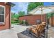 Private backyard patio with comfortable lounge seating, shade umbrella, and well-manicured landscaping at 1218 S Josephine St, Denver, CO 80210