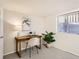 Basement office space with desk, chair, plant and a window providing natural light at 1218 S Josephine St, Denver, CO 80210