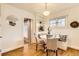 Cozy dining area with built-in bench seating, hardwood floors, and a charming round table at 1218 S Josephine St, Denver, CO 80210