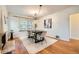 Charming dining room with hardwood floors, natural light, a fireplace and modern chandelier at 1218 S Josephine St, Denver, CO 80210