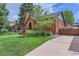 Beautifully landscaped front yard and brick home showing sidewalk leading up to entrance at 1218 S Josephine St, Denver, CO 80210