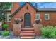 Welcoming front entrance with brick steps, flower-filled urns, and an arched front door at 1218 S Josephine St, Denver, CO 80210