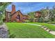 Quaint brick home with a well-manicured lawn and sidewalk, showcasing curb appeal at 1218 S Josephine St, Denver, CO 80210
