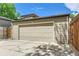 A detached two car garage with ample parking space on a concrete parking pad at 1218 S Josephine St, Denver, CO 80210