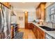 Stylish kitchen features stainless steel appliances, granite counters, and warm wood cabinets at 1218 S Josephine St, Denver, CO 80210