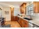 Well-lit kitchen with warm wood cabinets, granite countertops, and hardwood floors at 1218 S Josephine St, Denver, CO 80210