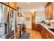 Stylish kitchen features stainless steel appliances, granite counters, and warm wood cabinets at 1218 S Josephine St, Denver, CO 80210