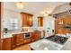 Well-lit kitchen with warm wood cabinets, stainless appliances, and hardwood floors at 1218 S Josephine St, Denver, CO 80210